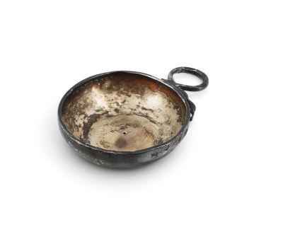 a small metal bowl with a handle on a white surface