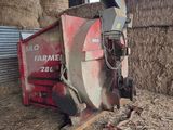 a red tractor that is sitting in the hay
