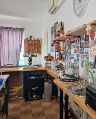 a kitchen with a lot of clutter on the counter