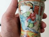 a person holding a vase with a picture of a woman on it