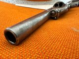 an old gun on a table with a hat on it