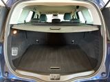 the back of a blue car with a surfboard in the trunk
