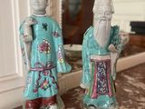pair of chinese figurines of a man and a woman on a table