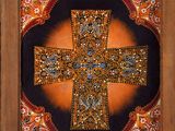 painting of a cross in a wooden frame with a black background