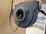 a blue blower that is attached to a wall