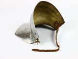 a metal helmet that has been left on the ground