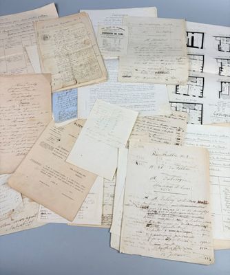 several old papers are stacked on top of each other on a table