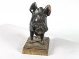 statue of a boar on a wooden base on a white background