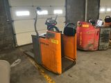 two forklifts that are parked in a garage