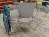 four chairs and a table on the floor in a room