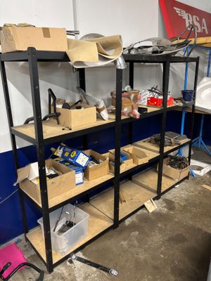 many shelves with various items on them in a room