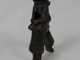 a figurine of a man in a hat and coat