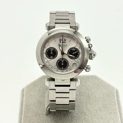 a silver watch with a white face on a display stand