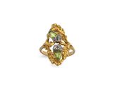 a close up of a gold ring with two green stones