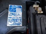 a close up of a car ' s engine with a sticker on it