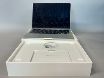 a laptop computer sitting in a white box on a table