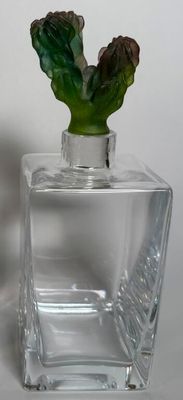 a small glass vase with a green plant inside of it