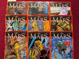 six albums de BD posés sur une surface rouge