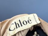 a close up of a purse with a name tag on it