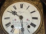 a clock that has roman numerals on the face of it