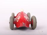 a red toy car that is sitting on a white surface