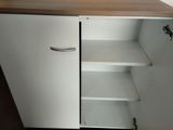 a white cabinet with a wooden top in a room