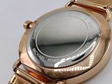 a close up of a wrist watch on a white surface