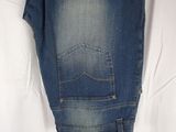 the back of a pair of jeans hanging on a hanger