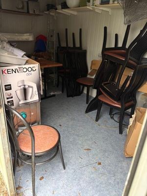 a room with a bunch of chairs and a table in it