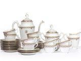 un service à thé blanc et or avec tasses et soucoupes