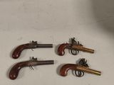 three old guns are sitting on a table next to each other