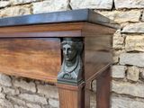 an antique console table with a bust on top of it