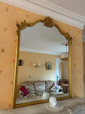 a mirror on the wall above a sink in a living room