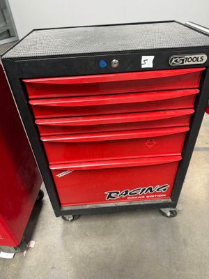 a close up of a red tool cabinet in a garage