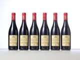 six bottles of red wine lined up in a row