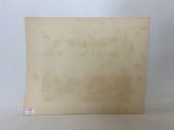 an old photo of a piece of paper on a white surface