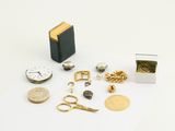 a small box of gold jewelry and a pair of scissors