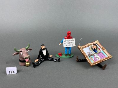 several figurines of people with signs and pictures on a table