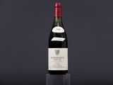 a bottle of wine sitting on top of a black table