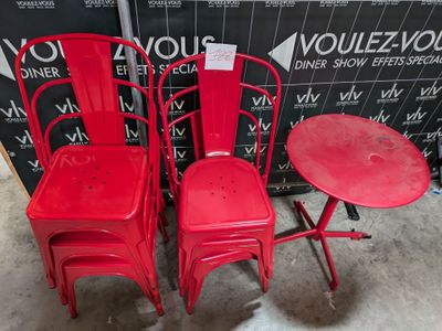 three red chairs and a table in a room