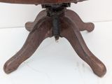 a wooden table with a metal base on a white surface
