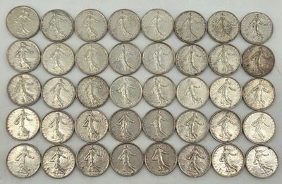 a pile of silver coins sitting on top of a white surface