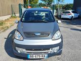a small car that is parked on the side of the road