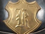 a close up of a helmet with a gold emblem on it