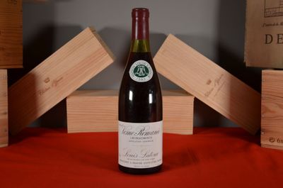 a bottle of wine sitting on a table next to wooden blocks