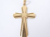 a gold cross pendant on a white background