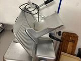 an image of a commercial meat slicer in a kitchen