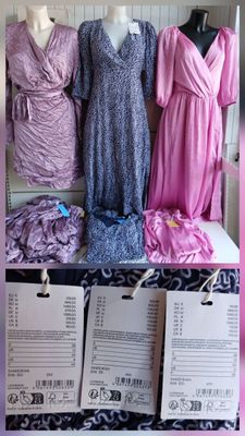 several dresses on display in a store with price tags on them