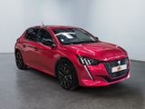 the red car is parked in a room with a white wall