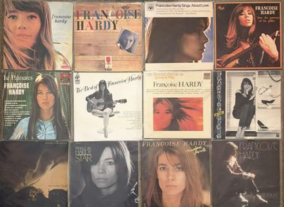 a lot of records on the wall of a room